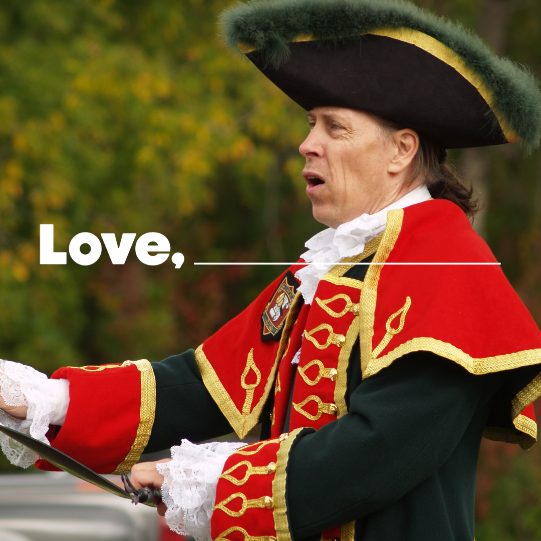 Town crier holding a scroll and making a proclamation 